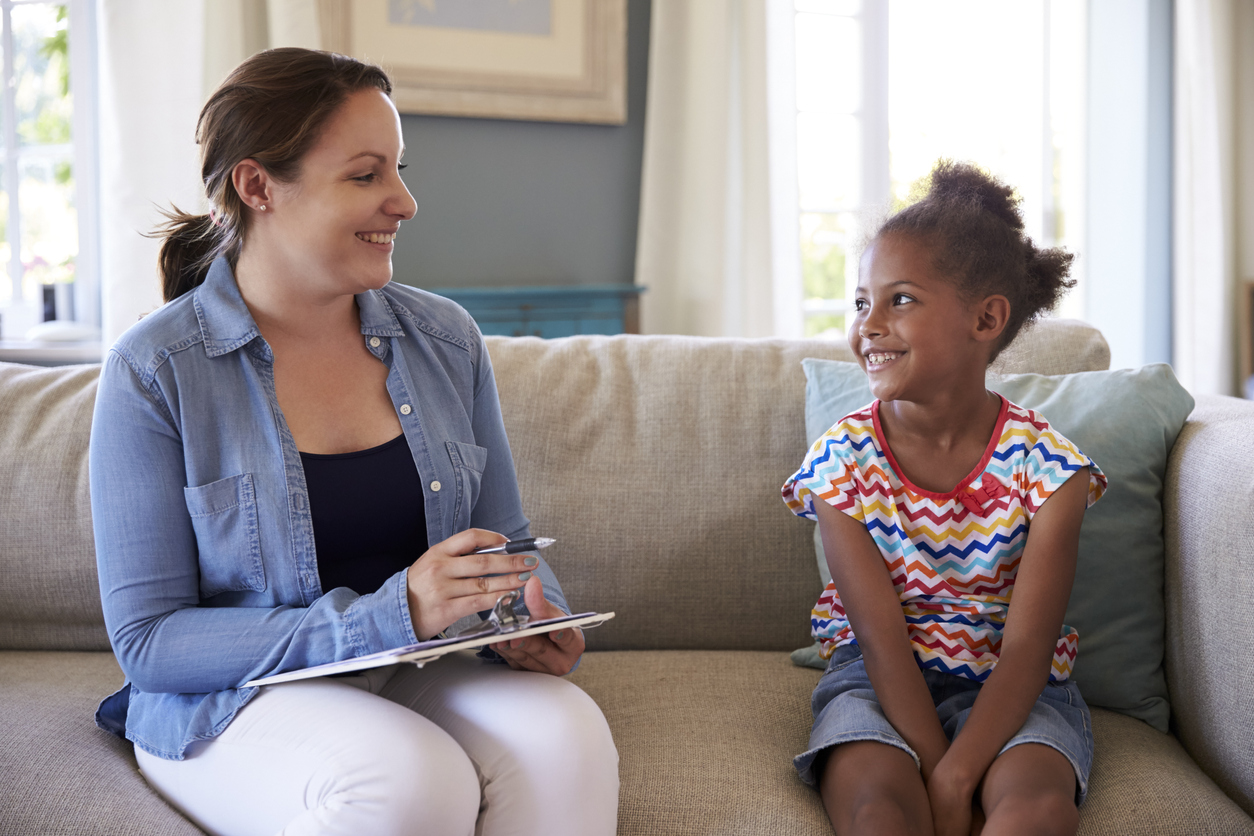Young Girl Talking With Counselor At Home